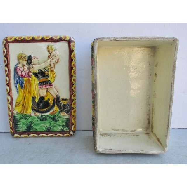 Italian faience from the 1940s. A neoclassic scene of the happy papa coming home from war to meet his infant son. Clad in...