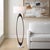 The Elongated, Open Oval Base Is Finished In A Rich Dark Bronze, Resting Elegantly On A Substantial Round White Marble...