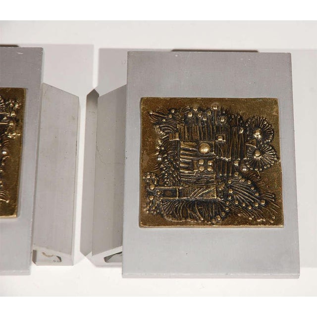 Pair of brass and aluminum door handles from a Belgian storefront. Brass panels feature an abstract bas-relief. Handles...