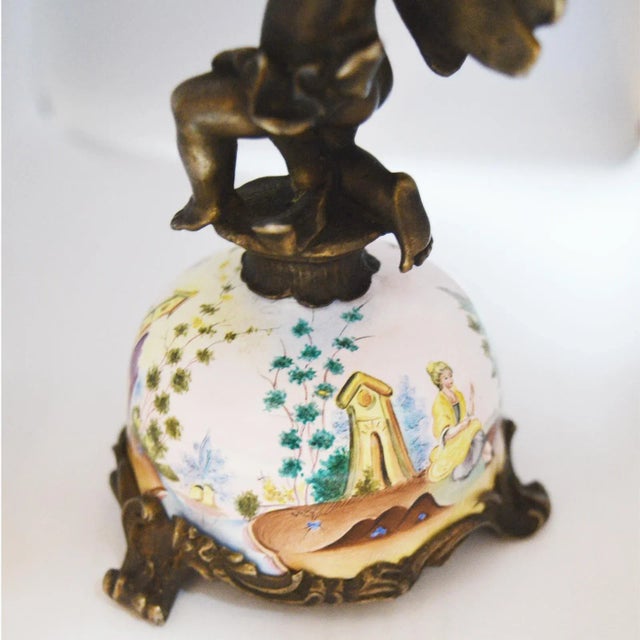 Miniature Austrian Enamel Sterling Silver & Bronze Desk Clock Bronze case with figure of a winged putti kneeling on the...