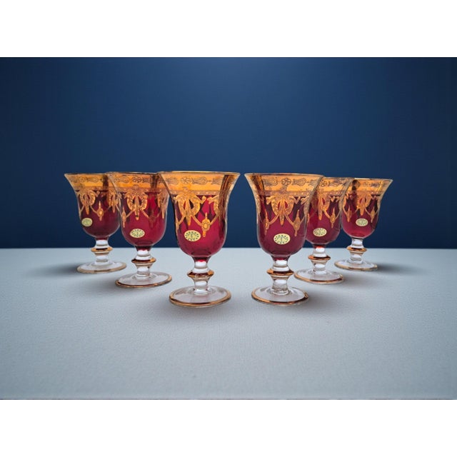 Crafted with the typical Murano craftsmanship, these goblets feature a deep ruby ​​red color with 24kt gold leaf...