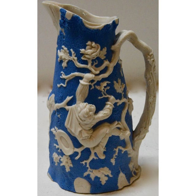A beautiful molded earthenware pitcher made by the Jones and Walley Co. of Cobridge, Stoke-on-Trent, England. The piece...