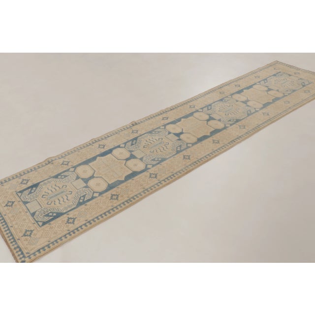 This vintage 3x11 Turkish runner is a refined hand-knotted wool weaving dating to circa 1950–1960. The piece features a...