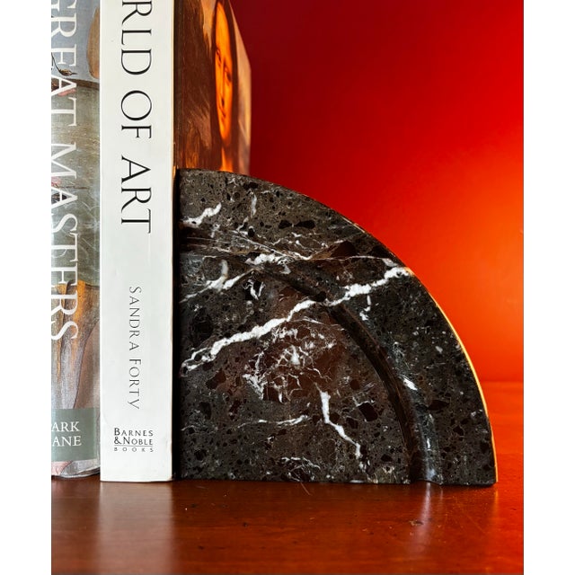 Solid black marble Demilune bookends with white veining.