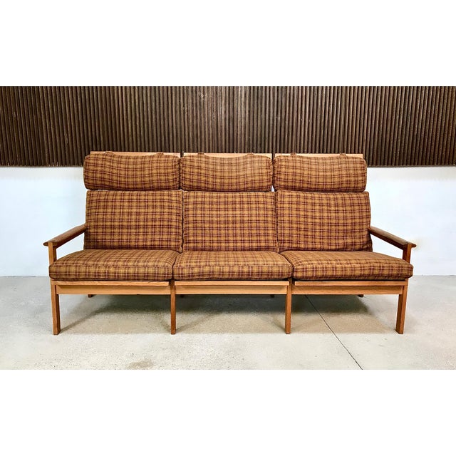 This Danish Capella highback 3-seater sofa was designed by Illum Wikkelsø in 1959 and was manufactured by Niels Eilersen...