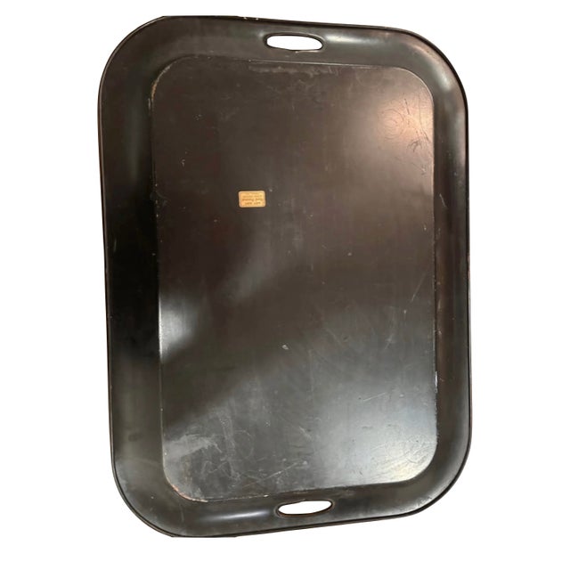 Large mid-20th-century American toleware tray, hand-painted with a central floral bouquet on a black japanned ground and...