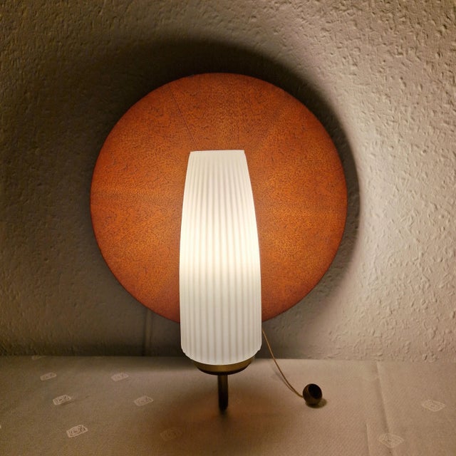 This stylish 1960s single-head wall lamp exudes mid-century modern charm. It features a frosted tulip-shaped glass shade...