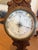 antique barometer with wood carving includes a dual-scale thermometer measuring temperature in both Fahrenheit and...