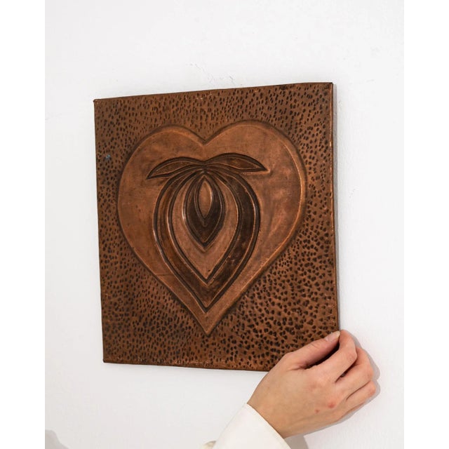 Graphic and eye-catching, this copper wall decoration makes a unique vintage accent. The square plaque is decorated with a...