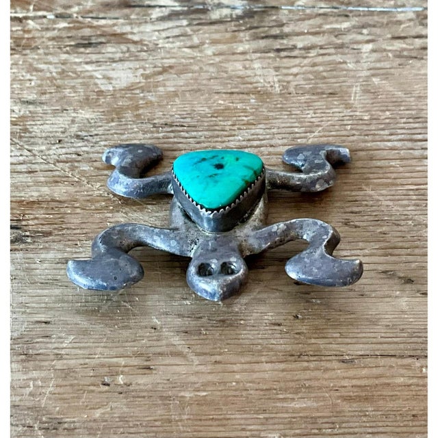 This striking vintage Native American silver inlaid turquoise pendant exemplifies traditional Southwestern artistry,...