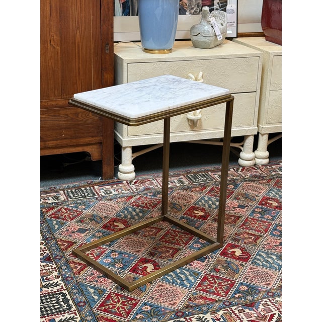 Design Plus Gallery presents a pair of C-Tables of Brass and Marble. The tables have a shape that works well as side...