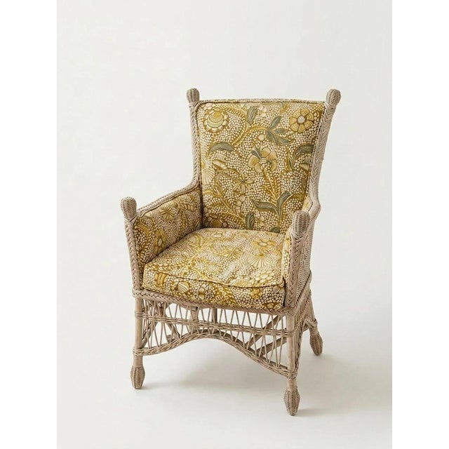 Vintage wicker chairs upholstered in Fermoie shell grotto fabric in yellow with removable cushion. Sold as a pair.