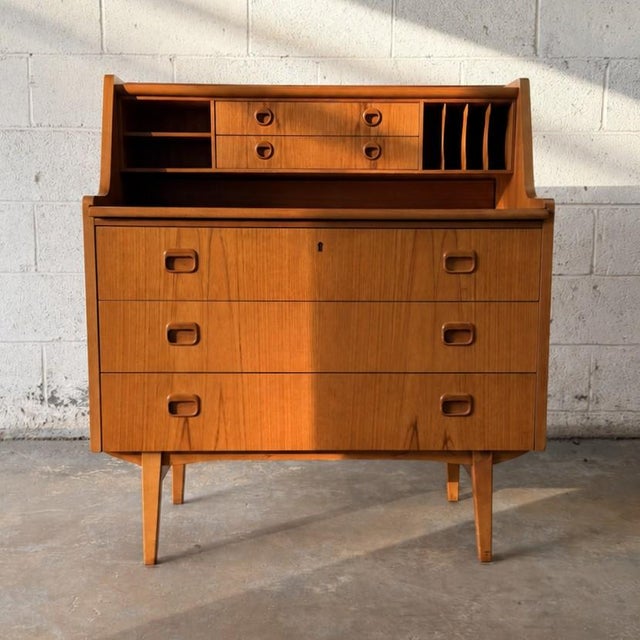 A sculptural Swedish teak chatol secretary desk by Egon Ostergaard, dating to the 1960s. Designed as a compact combination...