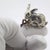 A delicate and expressive miniature, this vintage Italian piece depicts a bunny rabbit gently interacting with a small...