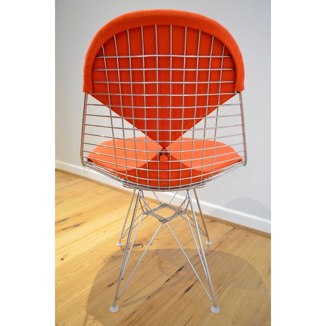 The "Bikini" wire chair was designed by Charles and Ray Eames for Vitra. The chair features a chrome-plated wire seat with...