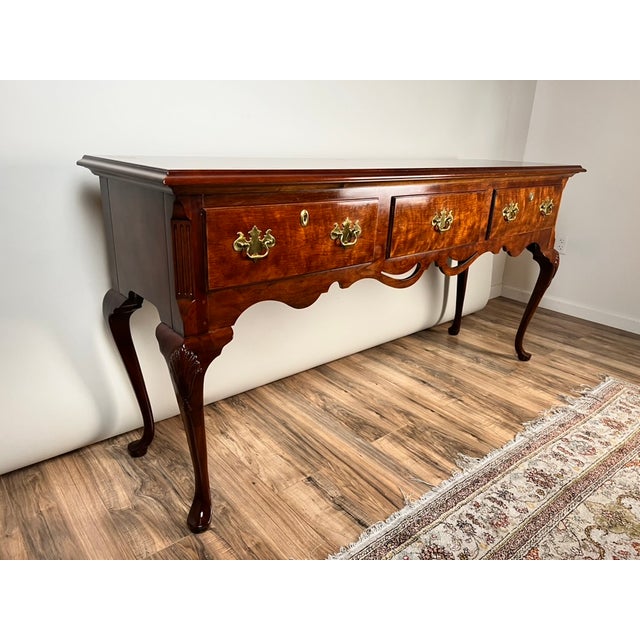 This vintage sideboard by Henredon has a beautiful Queen Anne inspired form, with graceful cabriole legs, shaped apron,...