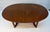 Elegant Mid-Century Modern oval dining table by Stanley, featuring a beautifully figured walnut top and a clean,...