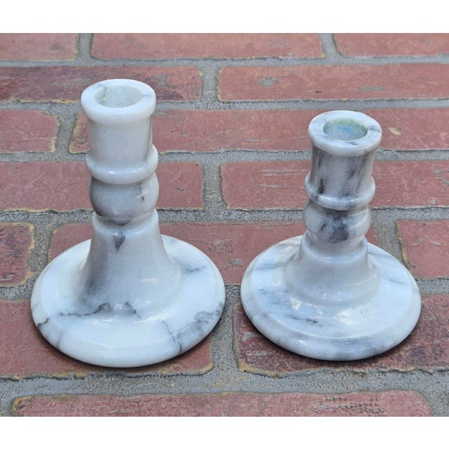 A beautiful pair of vintage solid marble candlestick holders featuring striking natural gray veining against a crisp white...