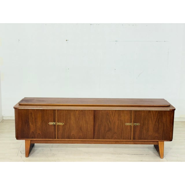 This stylish sideboard is for sale, boasting a timeless design with a beautiful wood grain and characteristic, slightly...