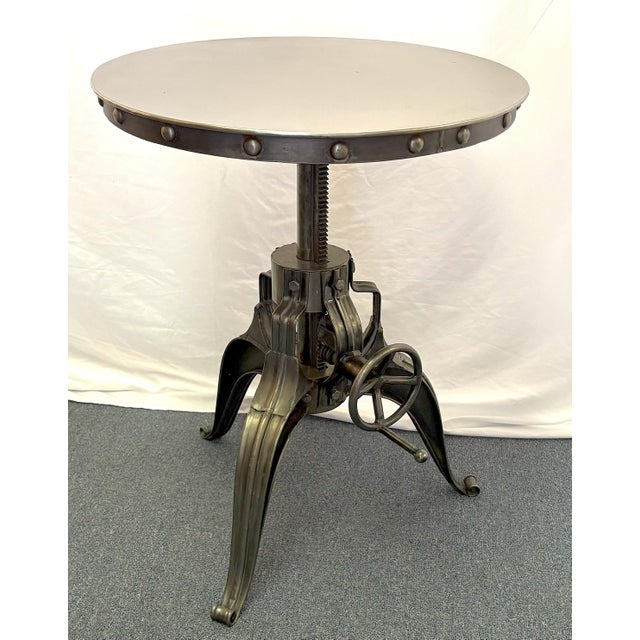 Cool Industrial style steel side table. The piece has a turning telescopic design and adjusts from a height of 20" to...