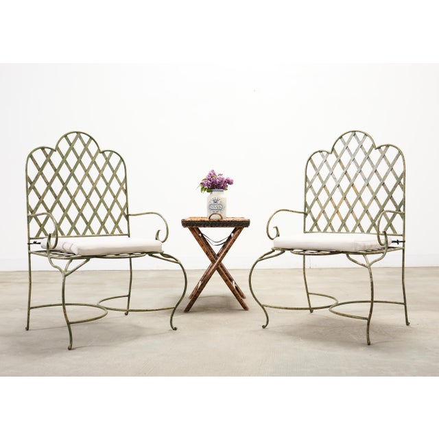 Whimsical set of four iron patio and garden armchairs made in the style and manner of Rose Tarlow. The chairs feature...