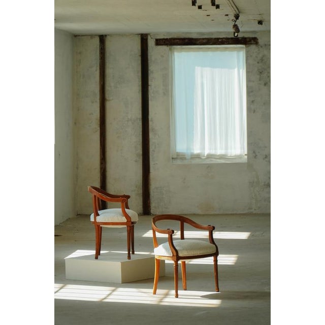 Elegant pair of Danish Art Nouveau armchairs from the 1920s, crafted in elm wood and recently reupholstered in a refined...