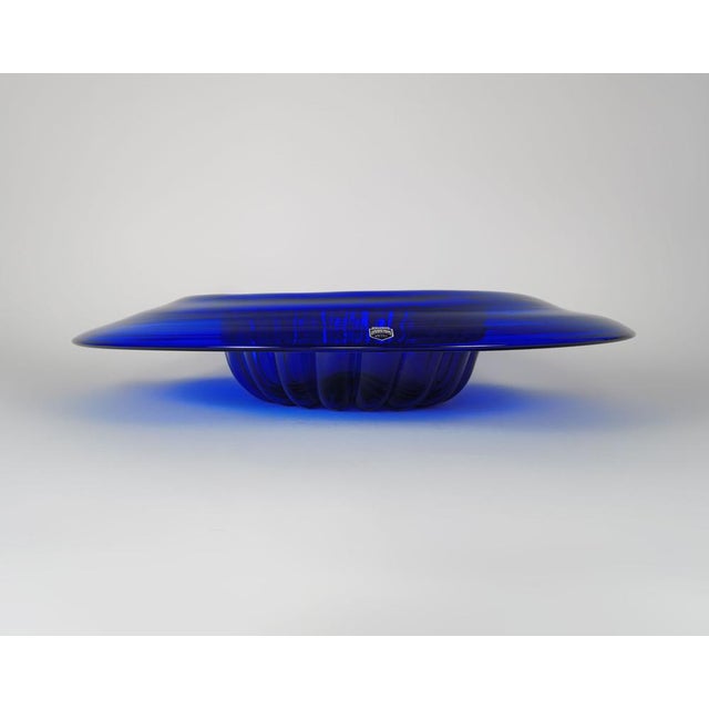 A very wide and very striking cobalt blue glass centrepiece bowl or dish with a wide, gently domed rim, and a jelly mould-...
