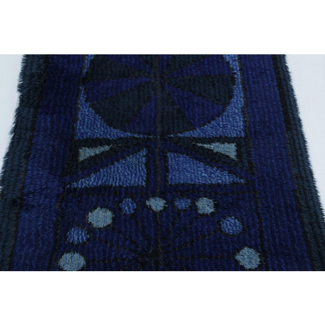 Hand-knotted in lush, high-pile wool in Sweden circa 1960-1970, this 3x5 vintage Swedish Rya rug is a bold new addition to...