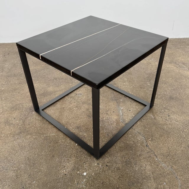Small but luxurious, this minimal side table with Sahara Noir Marble top and graphite steel base lets the materials do the...
