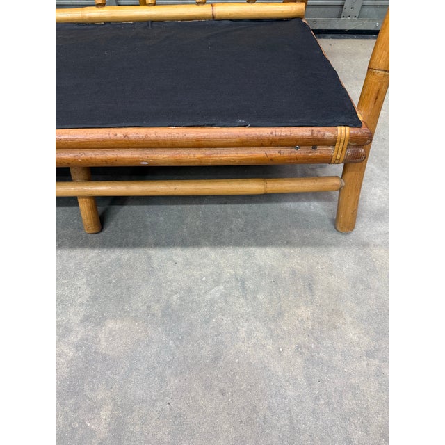 A fantastic bamboo and rattan bent wood mid-century sofa in a natural finish, featuring gold tone arm rest end caps. Three...