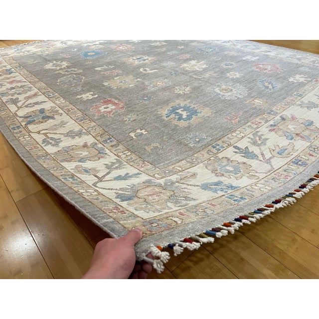 This handmade Persian Mahal-style rug from Afghanistan features a soft grey field decorated with floral and botanical...