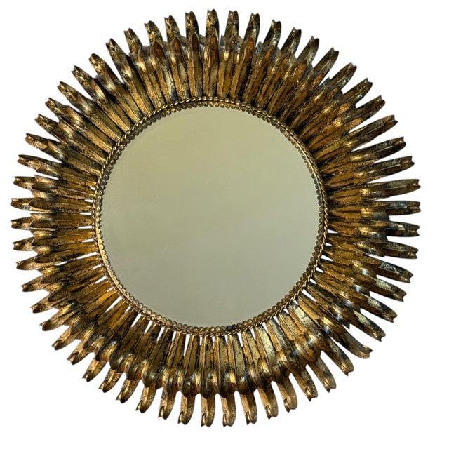 Round wrought iron sunburst mirror from the 1950s. Italian handcrafted, double leaf decoration.