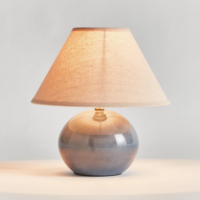 With a blue crackle glazed body and light linen shade, this lamp is a handsome fixture. At just around 10 inches tall, it,...