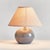 With a blue crackle glazed body and light linen shade, this lamp is a handsome fixture. At just around 10 inches tall, it,...