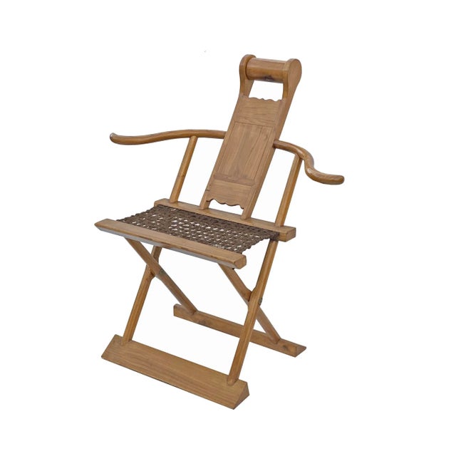 This is an oriental folding chair with a light brown color finish and wool mat seat. It has a simple slim wide arm design....