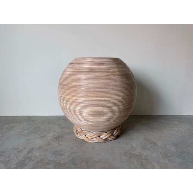 A beautifully sculptural vintage pencil-reed rattan dining table base showcasing the warm, organic elegance of Coastal...