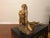 Female nude sculpture on a mirrored pedestal base. The resin sculpture is signed and dated '79. It sits on a piece of dark...
