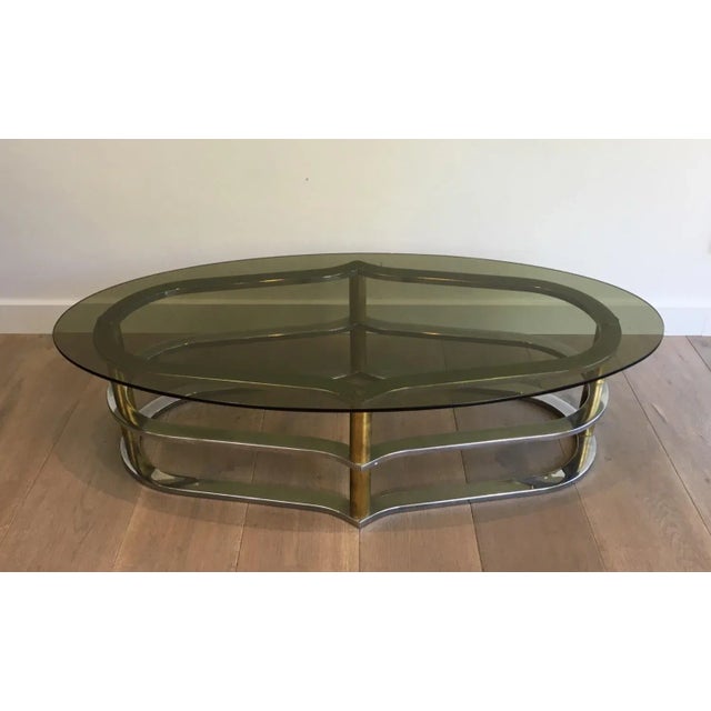 This unusual design coffee table is made of gilt brass and chrome. This cocktail table is a very unusual model of very...