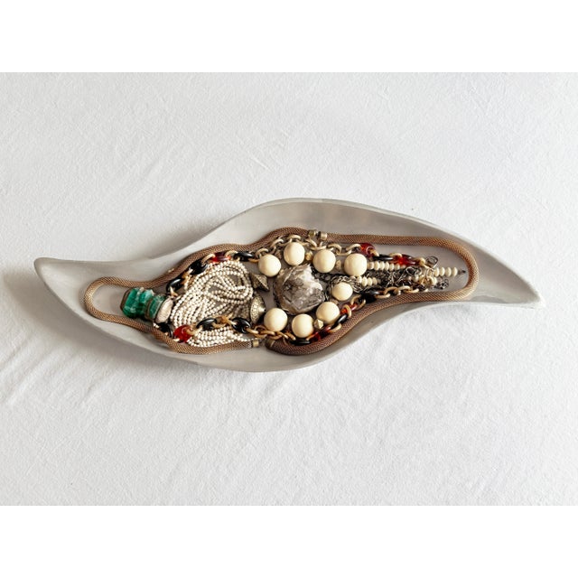 Vintage 1970s bohemian long necklace featuring creamy carved bone and/or shell beads in a dramatic, densely layered design...