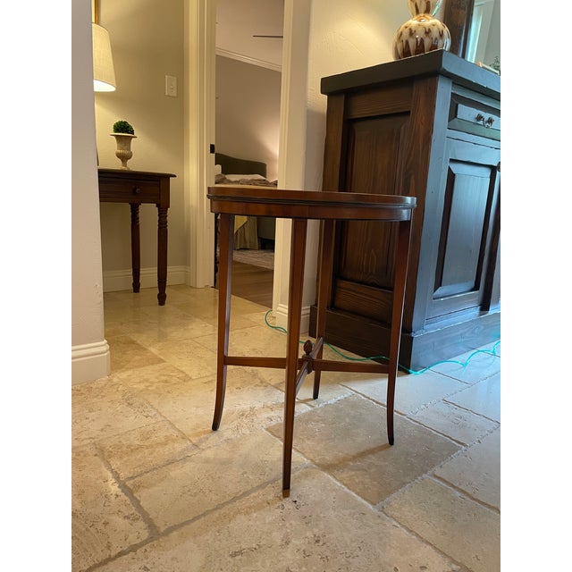 A refined vintage Grand Rapids side table crafted from solid mahogany, featuring a warm, rich tone and a classic oval...