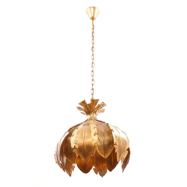 This brutalist brass hanging lamp is made of acid treated and flame cut brass. The lamp was designed by Svend Aage Holm...