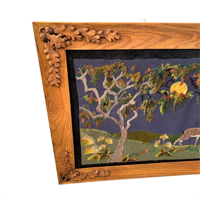 Early 20th-century rustic embroidered art depicting a moonlit forest scene with deer and trees set on a deep blue wool...