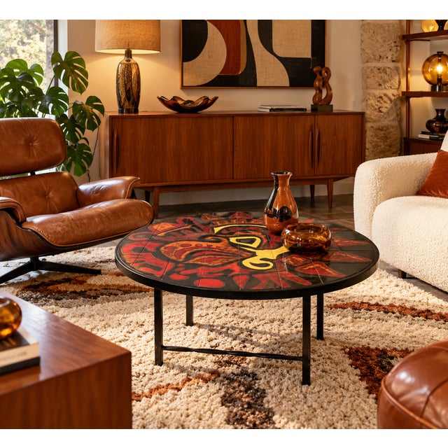 This round coffee table is distinguished by its magnificent ceramic tile top, adorned with a particularly expressive...