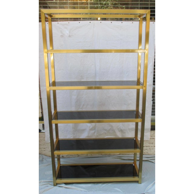 Satin Brass Etegere with six shelves in the design. The design measures 15.25" by 46" overall and 85" tall. The shelves...