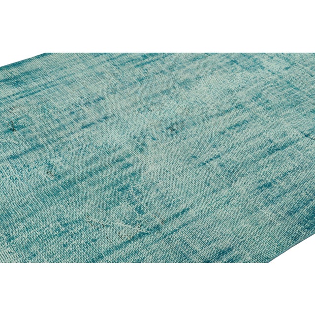 Hand-knotted in wool, this 5x8 vintage Turkish rug is from that collection of mid-century rugs with antique washes giving...