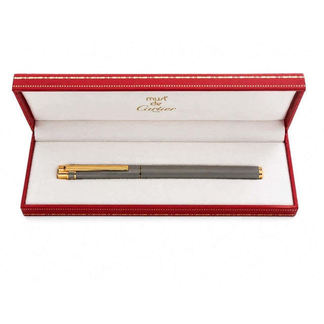 Vintage Must de Cartier Santos fountain pen, circa the 1990s, with a satin brushed-steel cap and barrel, polished gilt-...