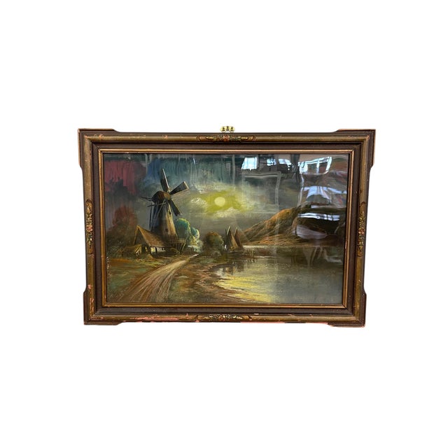 Framed landscape painting depicting a moonlit countryside with a traditional windmill, cottages, and a reflective...