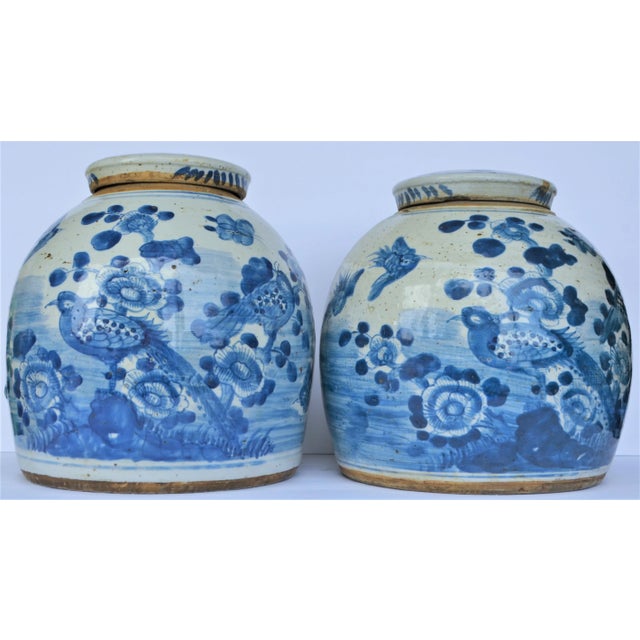 This fantastic pair of large blue & white Chinese porcelain ginger jars. These two rounded jars have a scene of beautiful...