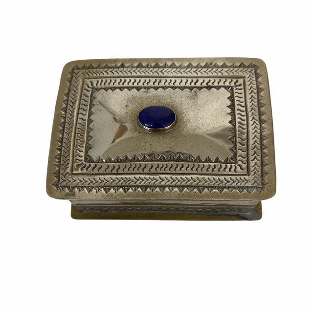 Mid century, silverplate, black velvet lined rectangular box, footed design with a hand-hammered, lid set with a central...