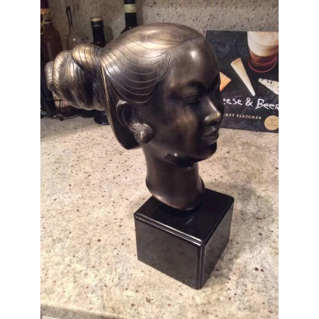 An exquisite example of an Asaian bronze art this bust of a woman is signed with a monogram on the back. It is mounted to...